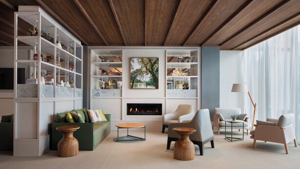 A modern living room with a fireplace, built-in shelving, and comfortable seating. - Element by Marriott Melbourne Richmond (Burnley)
