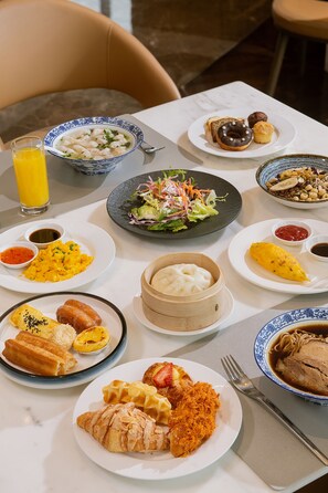 A table with various breakfast items including toast, eggs, waffles, and a bowl of soup. - Zhangjiagang Marriott Hotel (Suzhou)