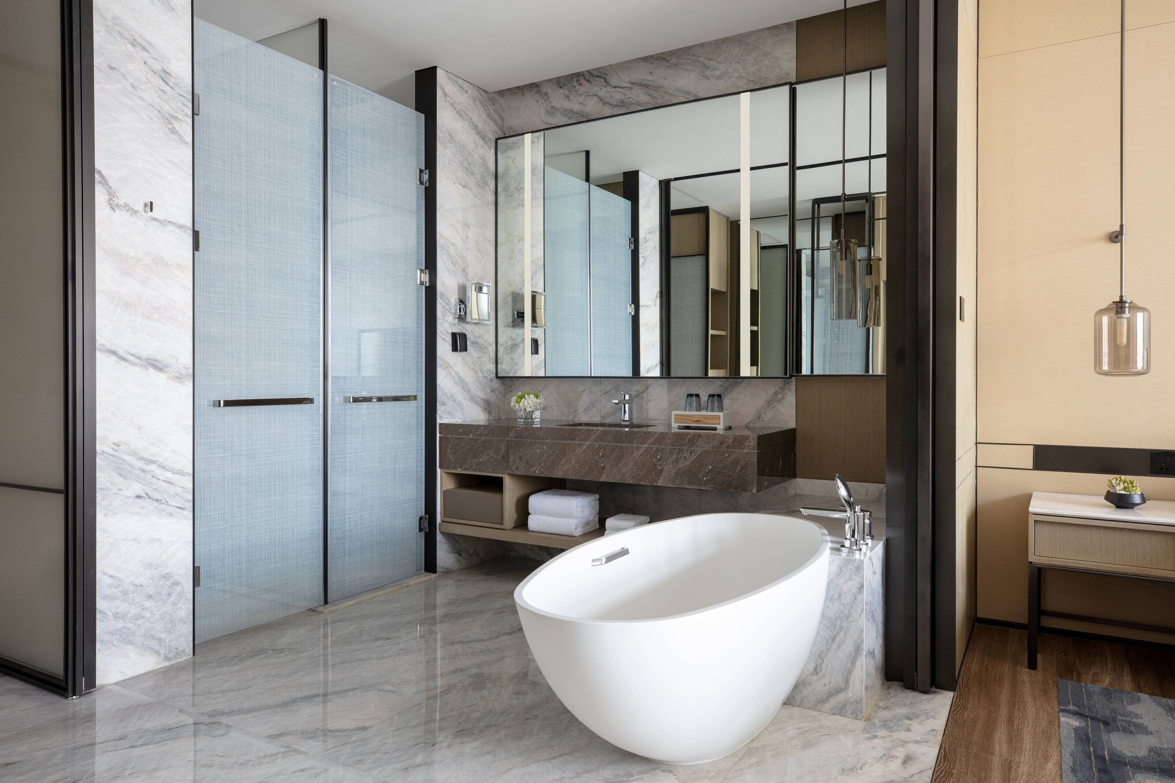 separate bathtub and shower, rainfall showerhead, designer toiletries