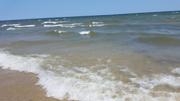 Una playa con olas que acarician suavemente la orilla.