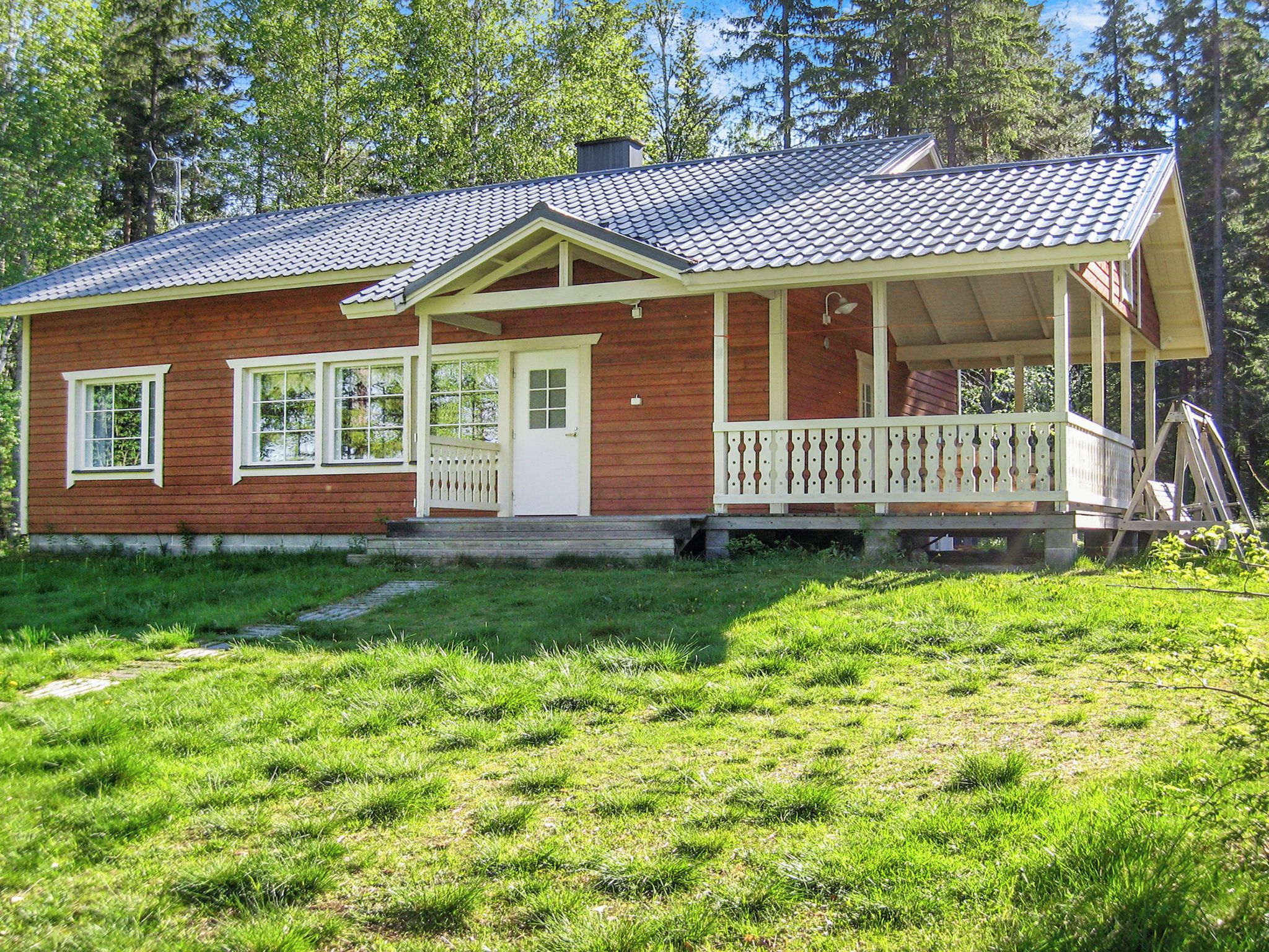 A two-story house with a porch and a covered front porch area.