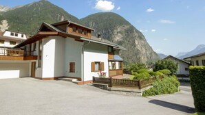 A two-story building with a balcony, set against a mountainous backdrop. - Vacation home Dialer by Interhome (Umhausen)