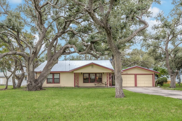 Set amidst a serene lawn and mature trees, this charming home offers a peaceful retreat.