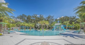 A swimming pool area with lounge chairs and a water slide structure. - Golden Palms Vacation Resort 1847 (Kissimmee)