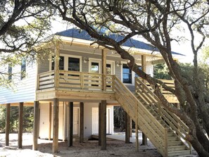 A wooden deck with a staircase leading to a house with a blue roof. - Newly Built 2019 Vacation Oasis- Enjoy 4WD Beaches & Wild Horses (Corolla)