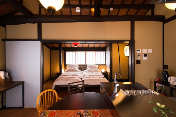A hotel room with a bed, a desk, a chair, a small table, and a sink. - 5` to imperial palace & subway. Boutique (Kyōto-shi)