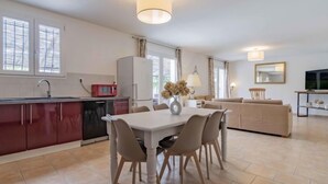 A modern apartment with a kitchen, dining area, and living room. - L' amandier by Interhome (Pernes les Fontaines)