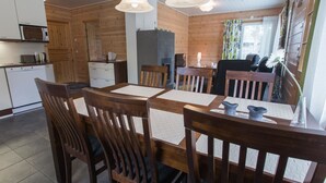 A cozy wooden cabin interior with a dining area, kitchen, and a cozy seating area. - Pihkala 2 by Interhome (Äkäslompolo)