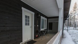 A wooden cabin with a porch, a door, and a window. - Pihkala 2 by Interhome (Äkäslompolo)