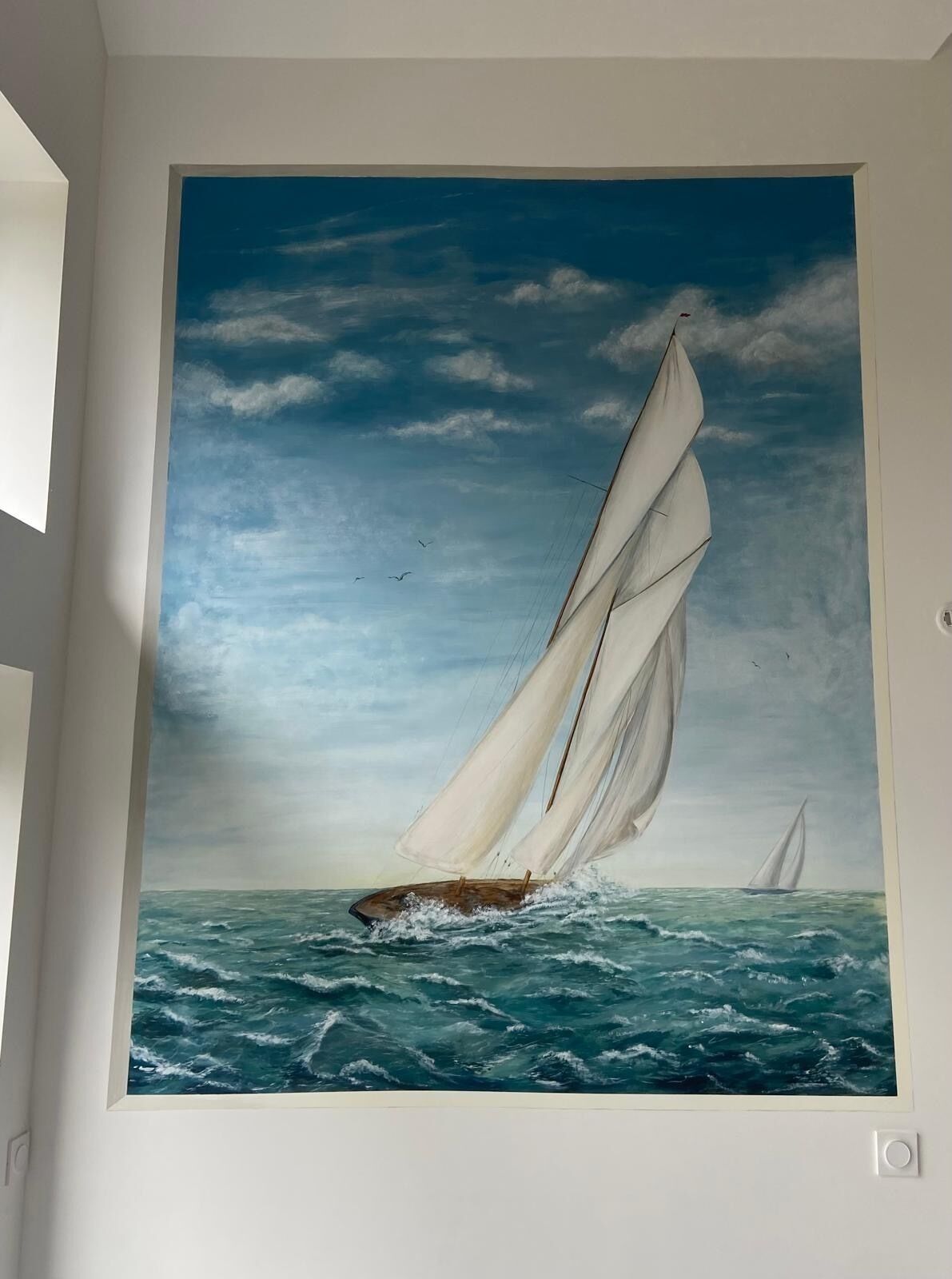 A painting of a sailboat on the sea with a clear sky.