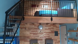 A loft-style room with a wooden floor, a staircase, a bunk bed, and a desk with a chair. - Ca 'De' Mumi, New Opening Old Town from 5 Apr '19 (Luino)
