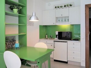 Fridge, microwave, cookware/dishes/utensils, dining tables