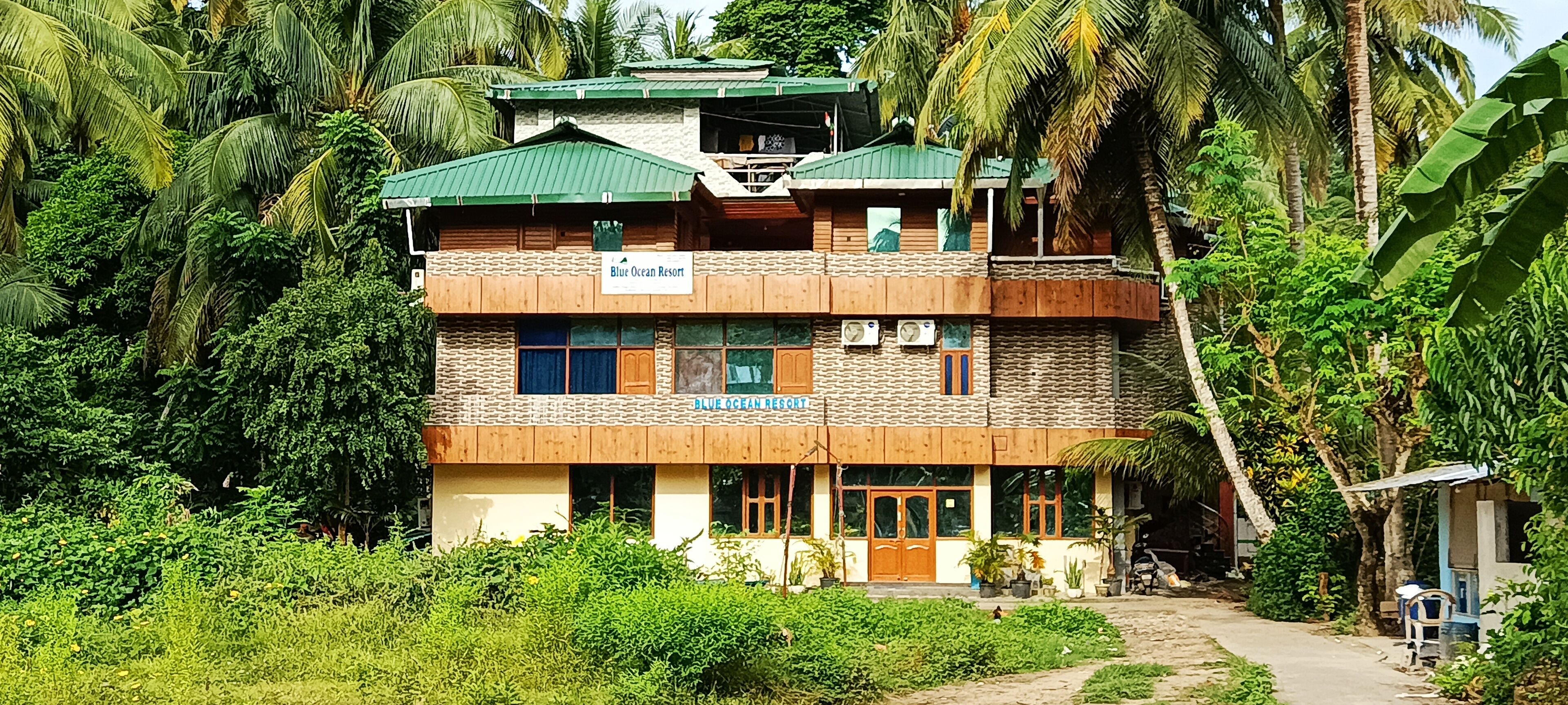 A two-story building with a sign reading "Blue Ocean Resort."