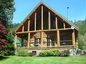 A log cabin with a large porch, stone foundation, and a chimney. - Hand-Scribed Log Home Pet-friendly, Hot Tub, AC, WIFI, Seasonal River Access (Randle)