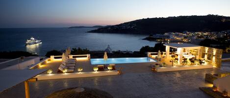 Seasonal outdoor pool, open 8:00 AM to 9:00 PM, pool umbrellas