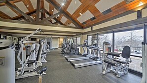 A gym with various exercise machines, large windows, and a wooden ceiling. - Alpine in the Ozarks~ right off back 40 trails (Bella Vista)