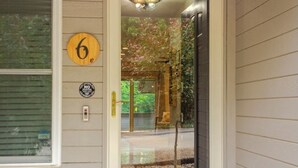 A house entrance with a glass door, a mailbox, a number '6' sign, a 'NO Soliciting' sign, and a small green tree. - Alpine in the Ozarks~ right off back 40 trails (Bella Vista)