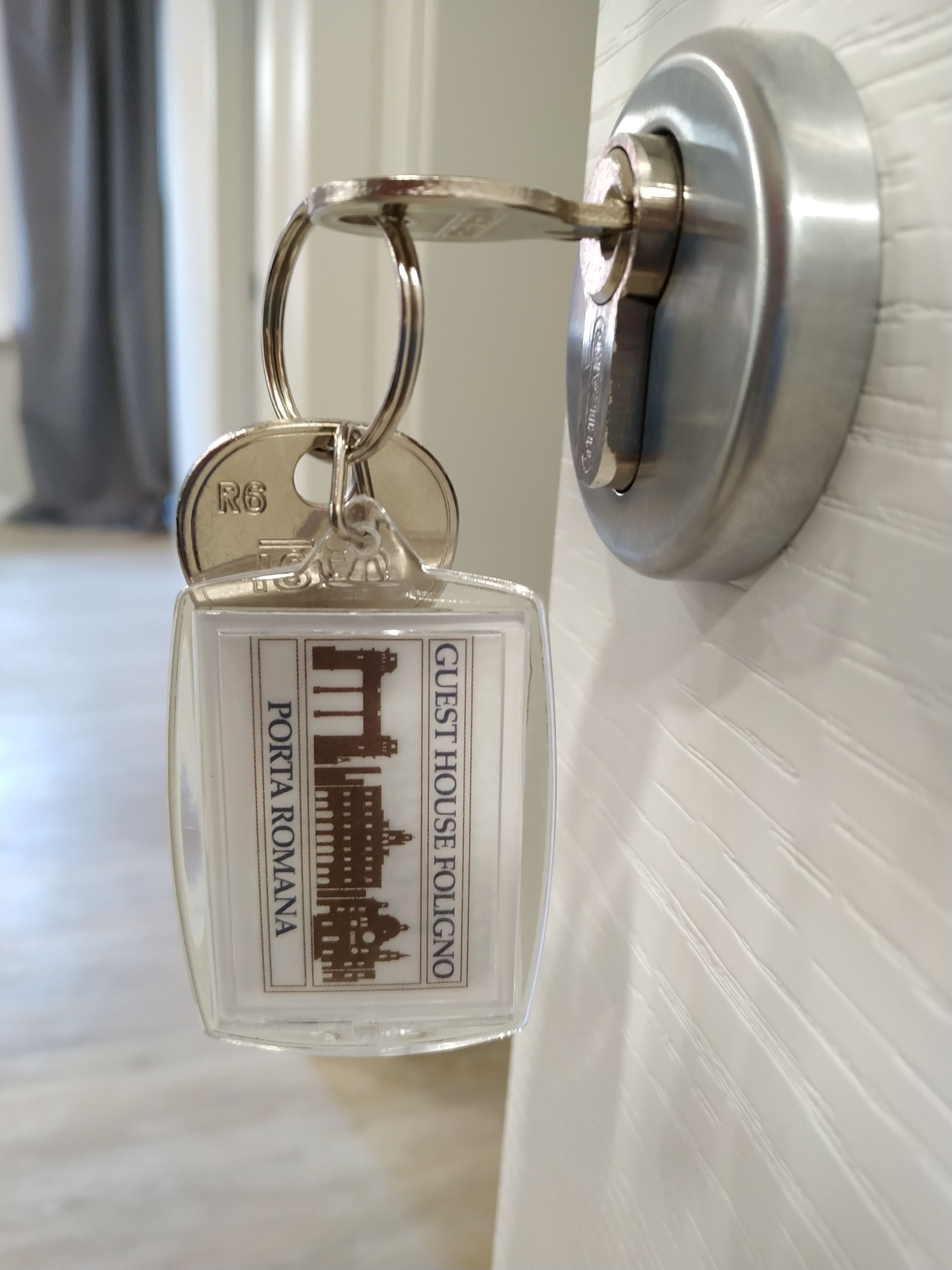 A keychain with a hotel name and logo.