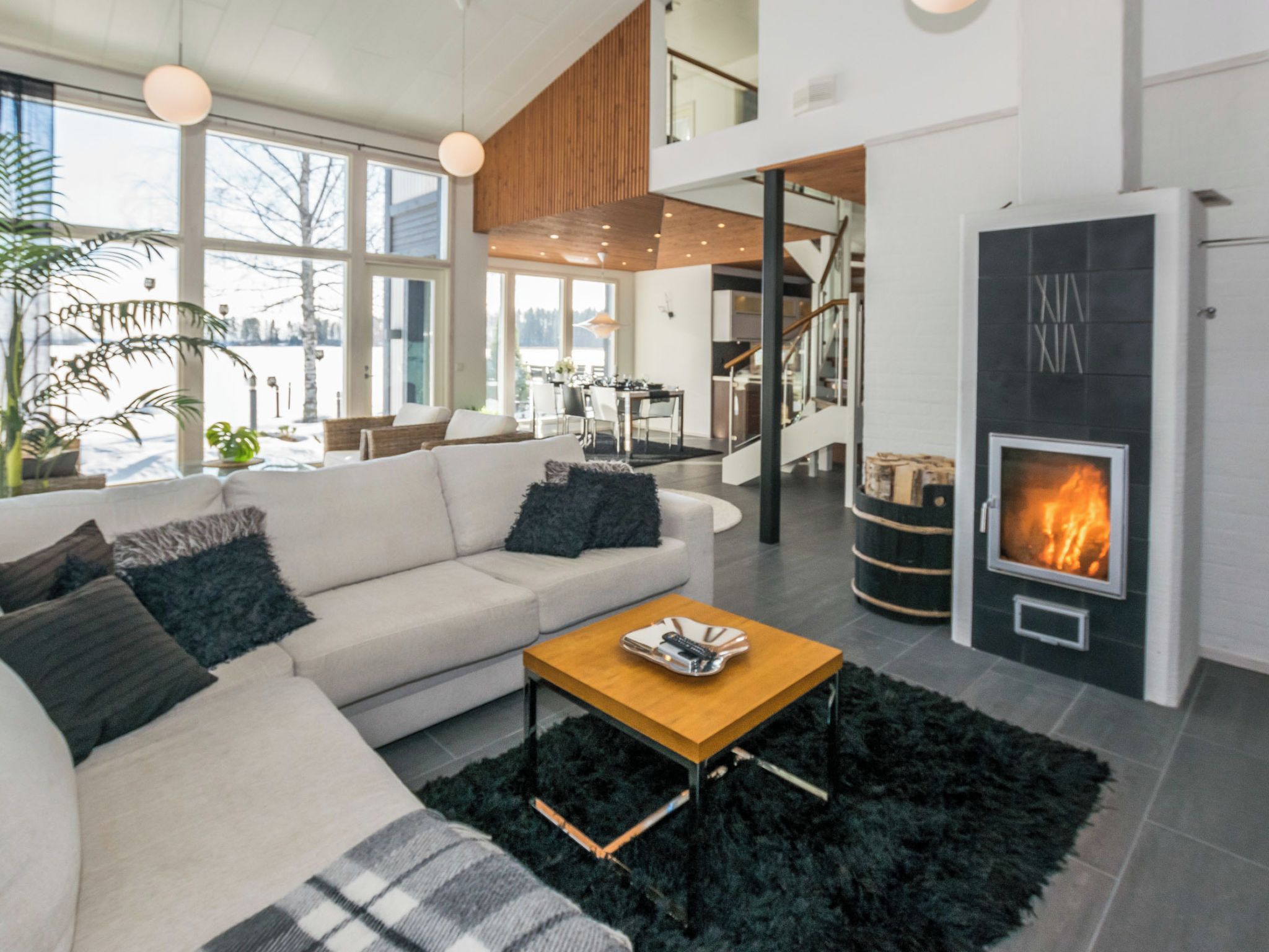 A modern living room with a sofa, coffee table, and fireplace.