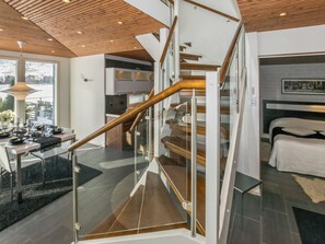 A modern interior with a spiral staircase, a dining area, and a bedroom. - Villa kaivopuisto by Interhome (Lavia)