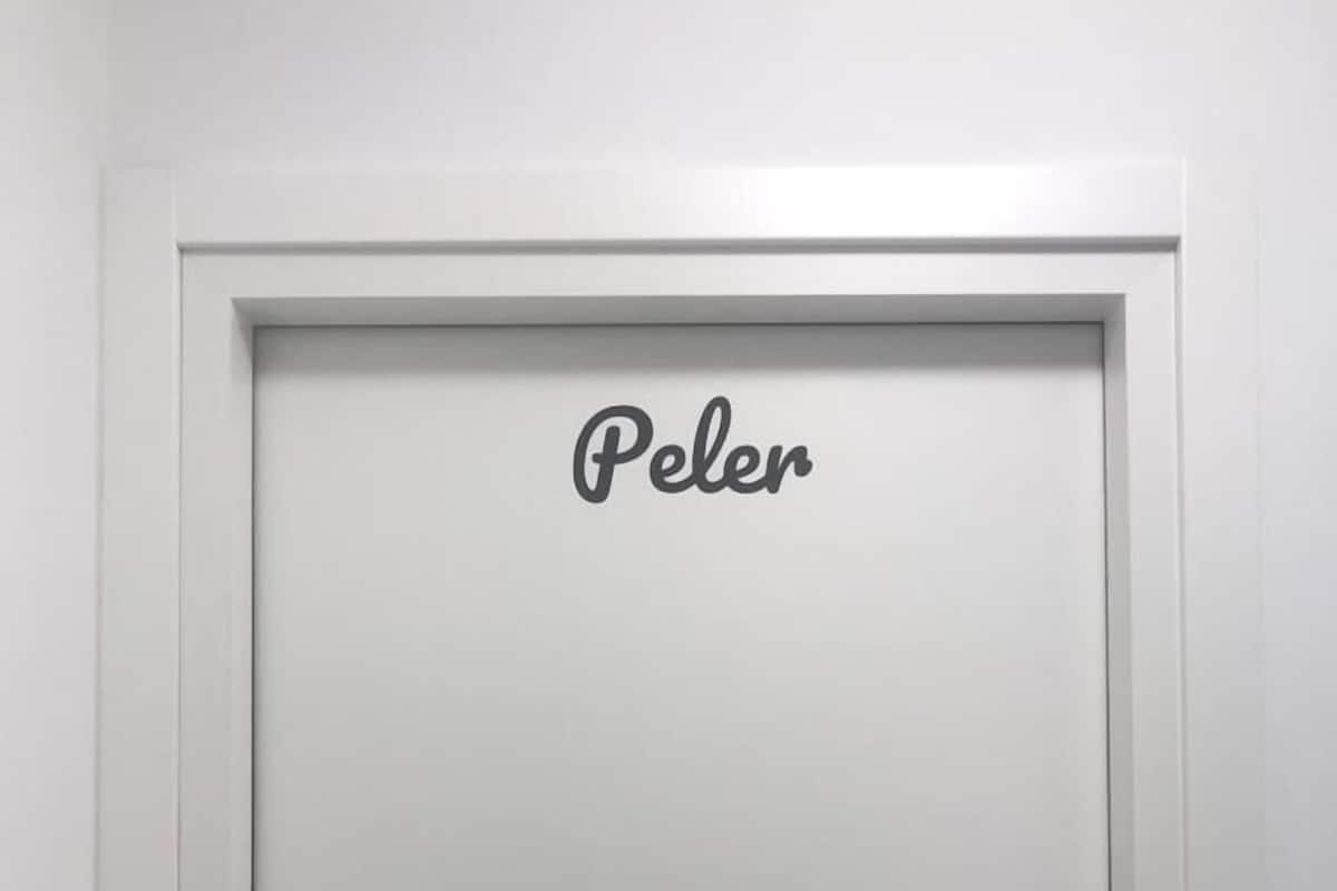 A white door with a nameplate reading "Peler" and a keyhole.