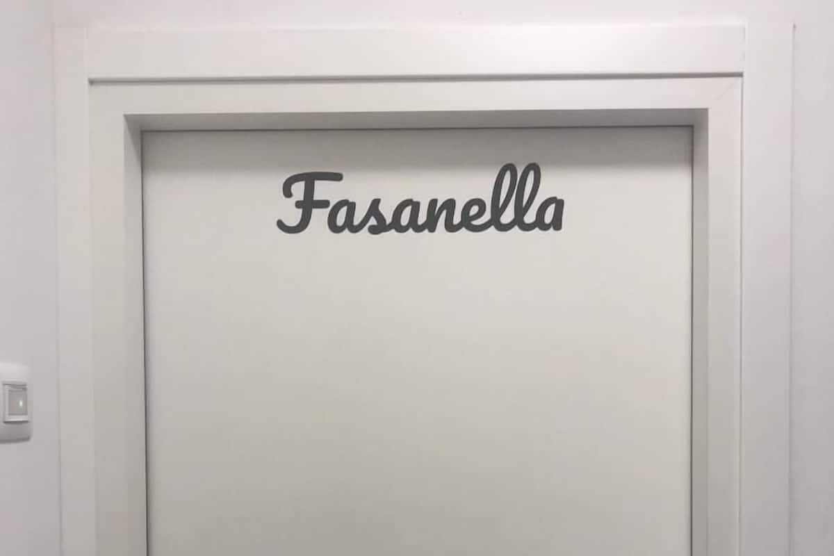A white door with the name "Fasanella" in a simple, elegant script.