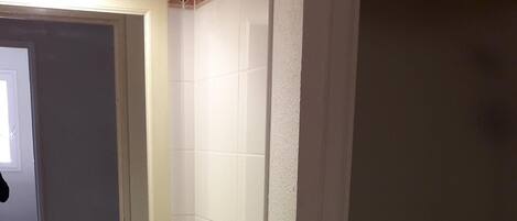 A bathroom with a white sink, mirror, and shower.