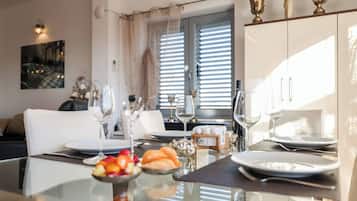 Apartment, Sea View | Living room | Flat-screen TV