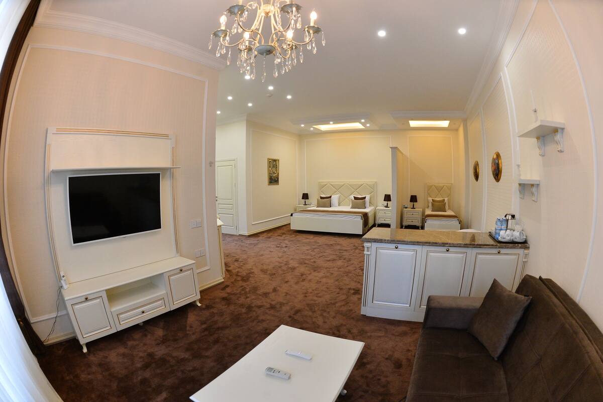 A living room with a TV, sofa, and coffee table.