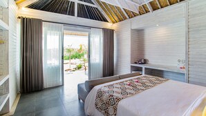 Un dormitorio con una cama grande, un banco, un escritorio y vistas al exterior.