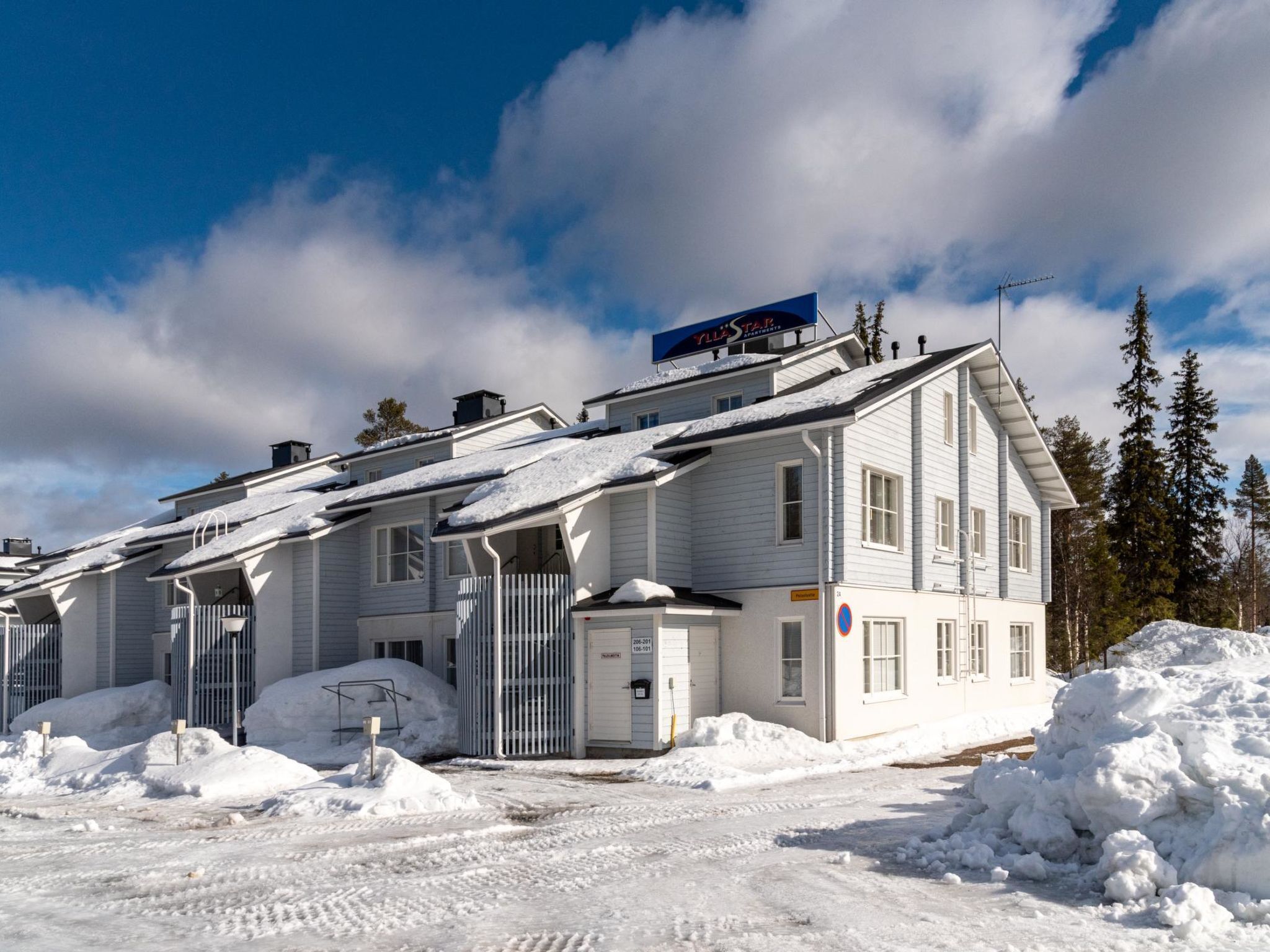 A multi-story hotel with a snow-covered roof and exterior.