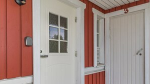 A white door with a window, a red door, and a number '3' above the right door.