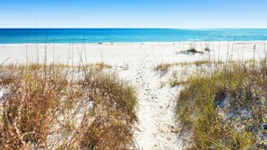 A sandy beach with a clear blue sky and ocean. - Beachfront | Pet Friendly | Gulf and Lagoon Views (Gulf Shores)