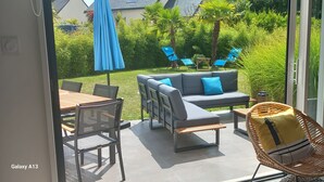 Un balcon avec un canapé, des chaises et une table.