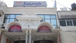 A hotel named "Saurab" with a classical facade, featuring two arched entrances and a prominent sign above. - Hotel Saurab (Dehradun)