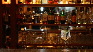 A bar with a variety of liquor bottles and glasses.