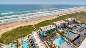 A resort with a beach view, multiple swimming pools, and a parking area. - Luxe 28th-Floor S Tower Condo: Ocean & SpaceX View (South Padre Island)