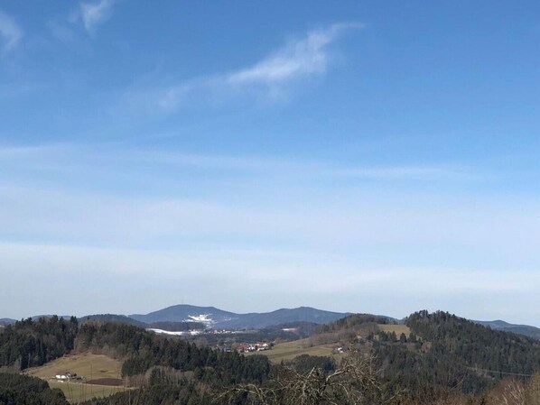 A panoramic view of a mountainous landscape with a clear sky.