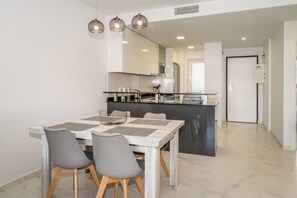 A modern kitchen with a dining area.