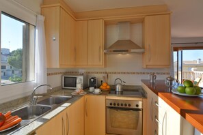 Fridge, microwave, stovetop, dining tables