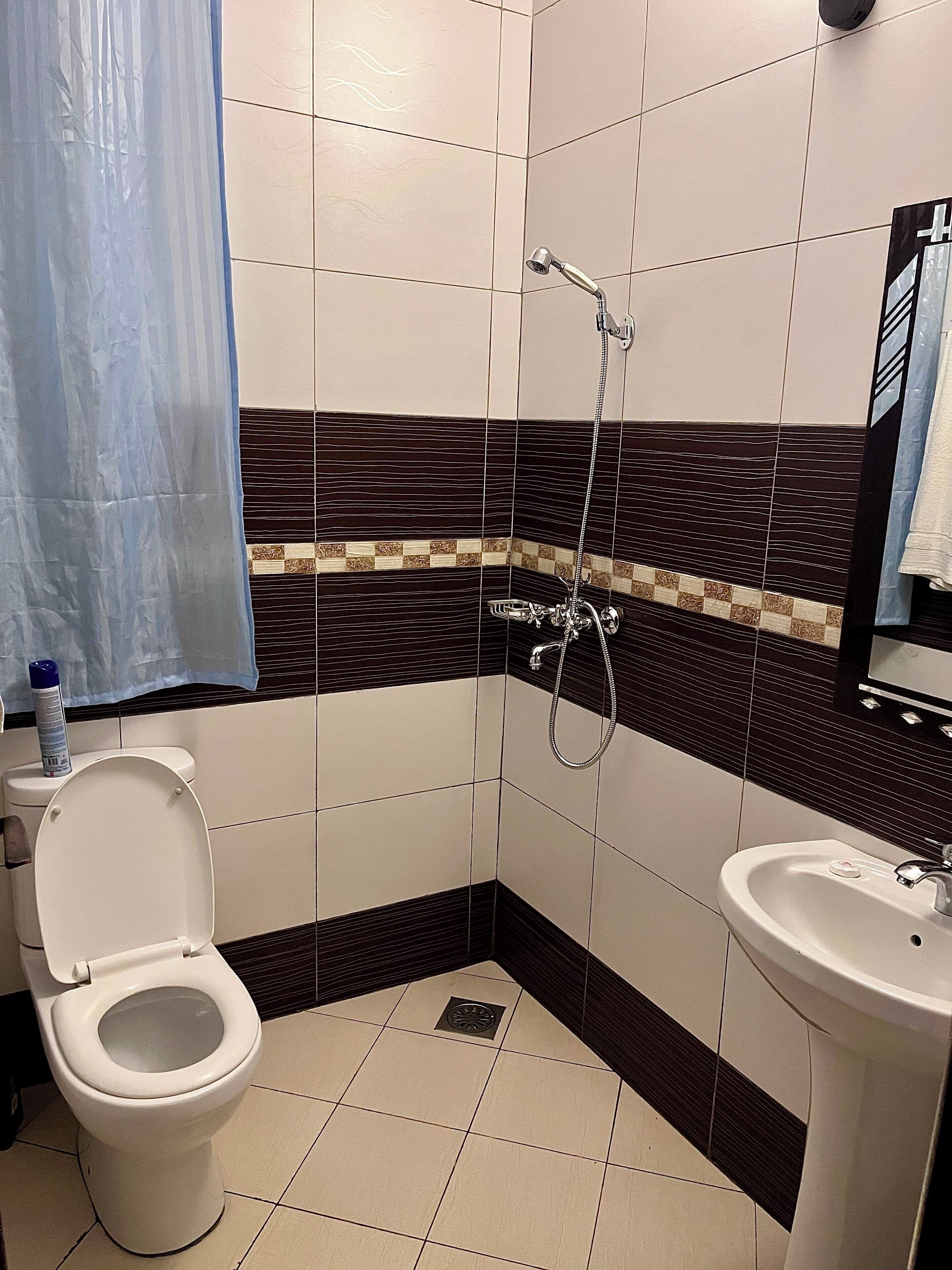 A bathroom with a toilet, bidet, and sink.
