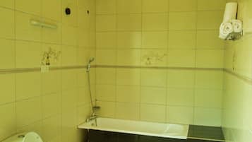 Un baño con inodoro, bañera y ducha.