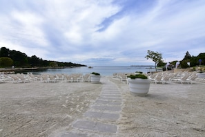 Relax on the beachside walkway, where lounge chairs line the path to the ocean.
