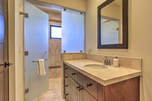 A bathroom with a double sink vanity, a large mirror, and a towel rack. - Golf Resort Condo w/ Ocean Views at Cabo Quivira (Cabo San Lucas)