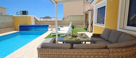 A heated pool, sun loungers