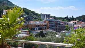 A hotel with multiple floors, balconies, and a pool area. - Apartments Raymond (Pržno)