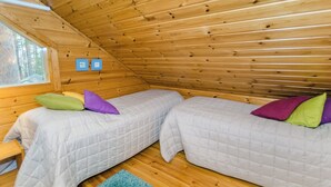 A small, cozy room with two beds, a window, and a blue rug. - Sammonranta by Interhome (Lieksa)