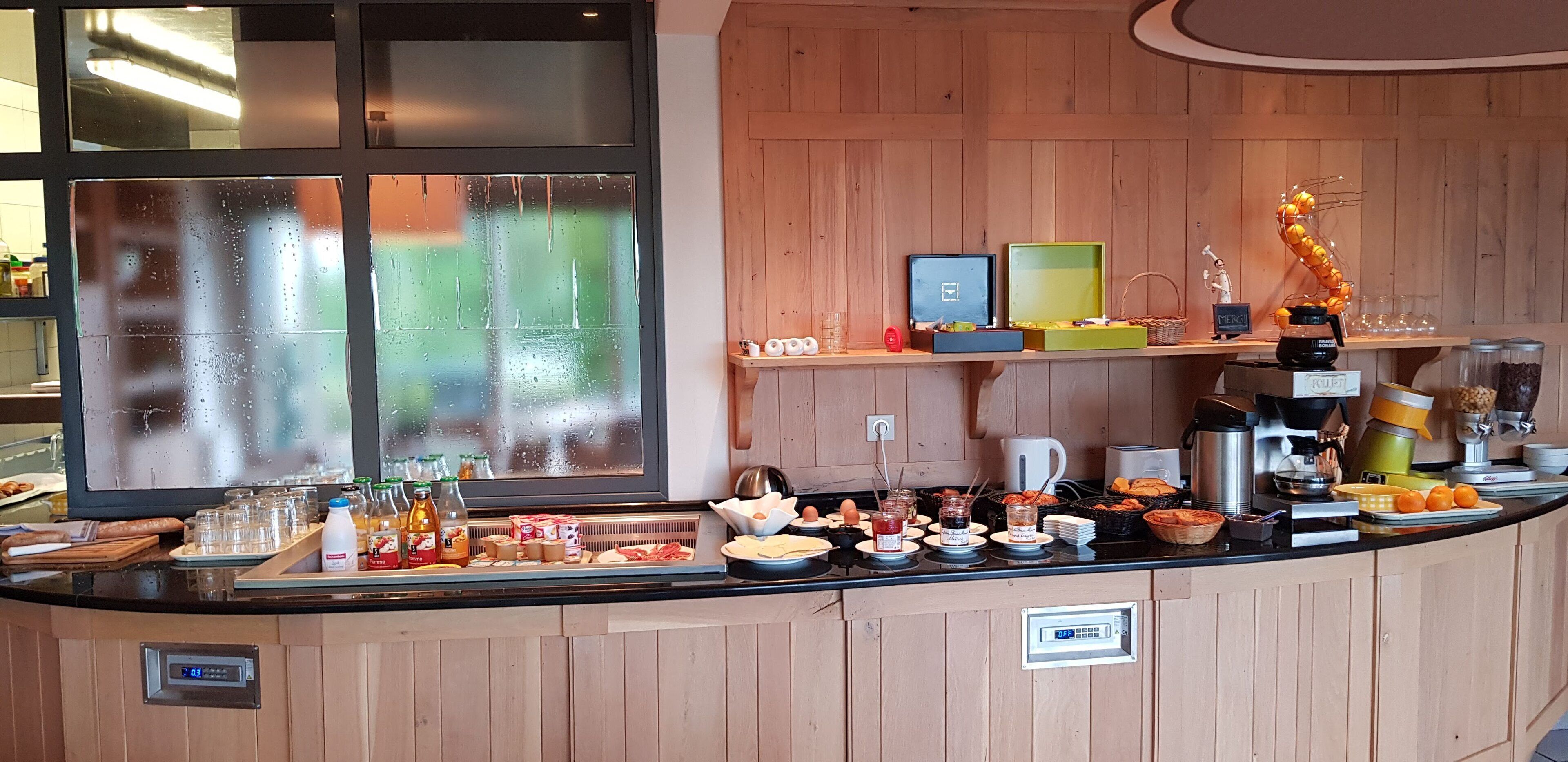 A breakfast buffet with various food items and condiments.