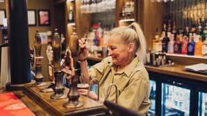 A bar with a counter, beer taps, and a variety of bottles in the background. - The Wheatley Arms (Ilkley)