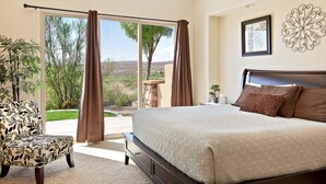A bedroom with a large bed, a chair, and a view of a landscape through a sliding door. - Golf Views on the Ridge GOLF VIEWS!! 2 Community Pools! (Washington)